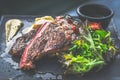 NZ ribeye steak, pan seared to medium rare, accompanied with real country creamy mashed potato, cherry tomatoes on vine, garden Royalty Free Stock Photo