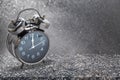 12 o`clock alarm clock on granite table with abstract background Royalty Free Stock Photo
