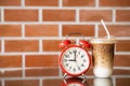 9 o`clock times for iced coffee concept. retro bell clock with ice latte coffee Royalty Free Stock Photo