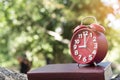 9 o`clock Vintage books and clock on wooden table outdoor with sunlight Royalty Free Stock Photo