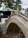 O-henro pilgrims on the stone bridge leading to Zentsuji, temple number 75 of Shikoku pilgrimage Royalty Free Stock Photo