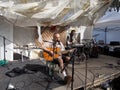 Guitarist and Drummer playing drums on stage