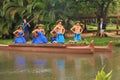 Oahu, Hawaii - 4/26/2018 - Hawaiian dancers performing while riding a canoe float at the Polynesian Cultural Center in Hawaii