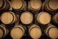 Oak barrels stacked for wine aging in winery cellar