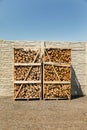 Oak and birch firewood is chopped and stacked in large boxes for sale. Preparing firewood for the winter