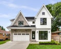 A modern farmhouse home with a white and brick exterior.