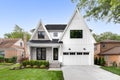 A modern farmhouse home with a white and brick exterior.