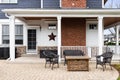 The backyard patio of a luxury blue and white modern farmhouse. Royalty Free Stock Photo