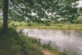 oak tree branches over summer river - vintage effect Royalty Free Stock Photo