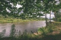 oak tree branches over summer river - vintage effect Royalty Free Stock Photo
