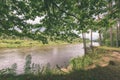 oak tree branches over summer river - vintage effect Royalty Free Stock Photo
