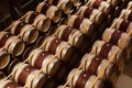 Oak wine barrels stacked in modern winery. View from above