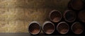 Oak wood barrel, wine beer casks stacked on the floor in a dark cellar, stone wall background. 3d render