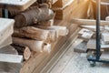 Oak wooden bar blocks materials stacked at carpentry woodwork workshop with tools and sawdust on background. Timber wood blanks at Royalty Free Stock Photo