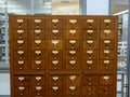 Oak wooden library catalog drawer sitting in a modern library Royalty Free Stock Photo