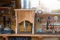 Oak wooden stool chair after resoring and repair at carpentry woodwork workshop with tools and sawdust on background. Timber wood Royalty Free Stock Photo