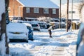 OAKHAM, RUTLAND, ENGLAND- 25 JANUARY 2021: Man shovelling snow in Oakham
