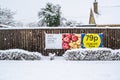 OAKHAM/RUTLAND, ENGLAND- 24 JANUARY 2021: Oakham TESCO clubcard price banner outside the supermarket on a snowy day