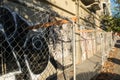 Oakland, abandoned burned out building with graffiti and chain link fence