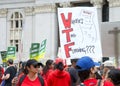 Teachers and supporters holding signs protesting at a Teacher Strike Rally in Oakland, CA