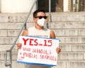 Unidentified protestor preparing for a cars and bicycle caravan promoting prop 15