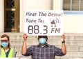 Unidentified protestor preparing for a cars and bicycle caravan promoting prop 15