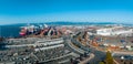 The Oakland Outer Harbor aerial view. Loaded trucks moving by Container cranes.