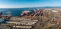 The Oakland Outer Harbor aerial view. Loaded trucks moving by Container cranes.