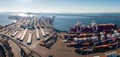 The Oakland Outer Harbor aerial view. Loaded trucks moving by Container cranes.