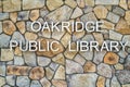 Oakridge, Oregon, USA - May 15, 2023: Lettering for the Public Library on the exterior stone wall