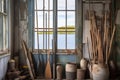 oars framed by a weathered window in a coastal shack