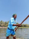 The oarsman of a coracle rowing in the waters of Cauvery in Talakadu Royalty Free Stock Photo