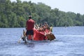 Oarsmen rowing a dragon boat on the river