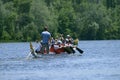 Oarsmen rowing a dragon boat on a river Royalty Free Stock Photo