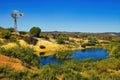 Oasis with windmill and small lake in the South Australian desert Royalty Free Stock Photo