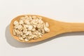 Oat cereal grain. Nutritious grains on a wooden spoon on white b Royalty Free Stock Photo
