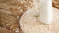 Oat flakes and bottle of fresh milk on a wooden board Royalty Free Stock Photo