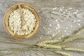 Oat flakes in bowl ,wooden spoon and and golden wheat ears.on wooden background. Royalty Free Stock Photo