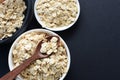 Oat flakes displayed in containers on gray background