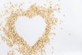 Oat flakes forming a heart shape on white background, conceptual image of good food for health. Royalty Free Stock Photo