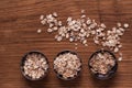 Oat flakes in metal bowl on brown wooden table Royalty Free Stock Photo