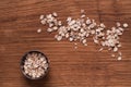 Oat flakes in metal bowl on brown wooden table Royalty Free Stock Photo