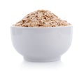 Oat flakes pile in white bowl on white