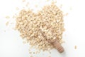 Oat flakes, rolled oats in heart shape with wooden scoop