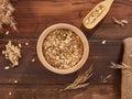 Oat flakes, rolled oats in wooden bowl on wooden table Royalty Free Stock Photo