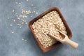 Oat flakes, rolled oats in wooden bowl with scoop