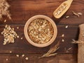 Oat flakes, rolled oats in wooden bowl top view Royalty Free Stock Photo