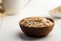 Oat flakes or rolled oats in wooden bowl on white plate. Royalty Free Stock Photo