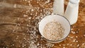 Oat flakes in white bowl and bottles of fresh milk Royalty Free Stock Photo