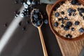 Oat granola with fresh blueberries and currants in a clay bowl over dark grunge surface. Top view, copy space. Wooden background. Royalty Free Stock Photo